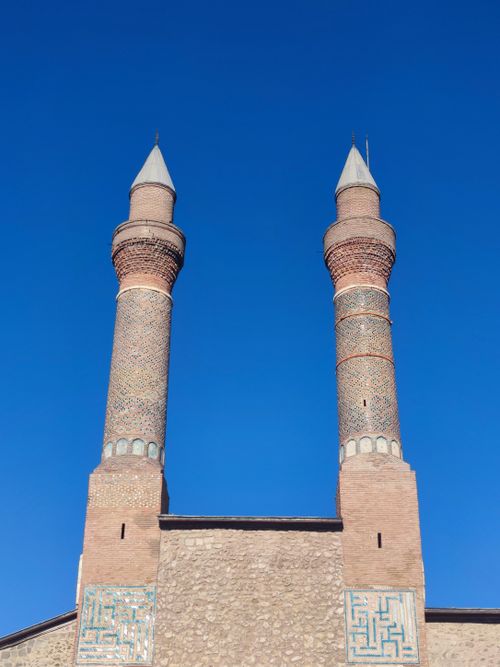 Free A striking view of the twin minarets of Sivas Grand Mosque against a clear blue sky. Stock Photo