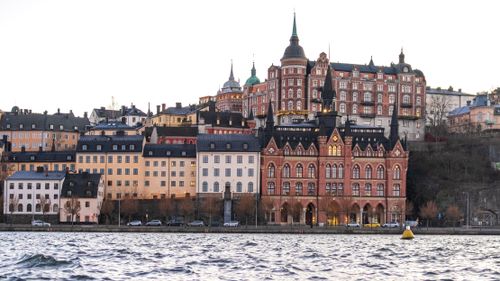 Free View of Stockholm's historic waterfront architecture during sunset, featuring Mariaberget's iconic skyline. Stock Photo