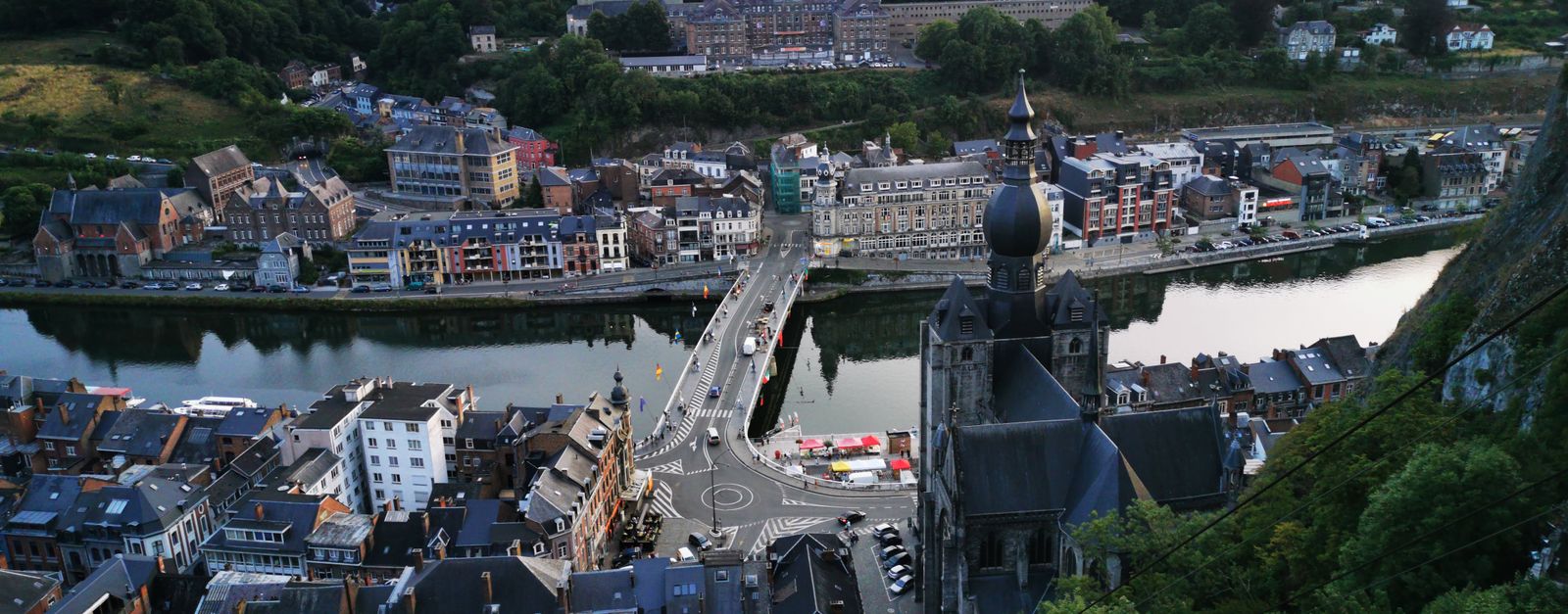 Aerial view of Dinant, Belgium showcasing the river, cityscape, and church.