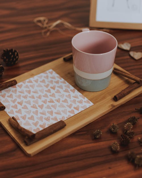 Pink, White, and Gray Ceramic Mug on Wooden Cutting Board