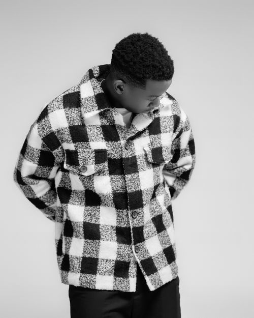 Free Monochrome portrait of a person wearing a checkered jacket in a fashion pose. Stock Photo