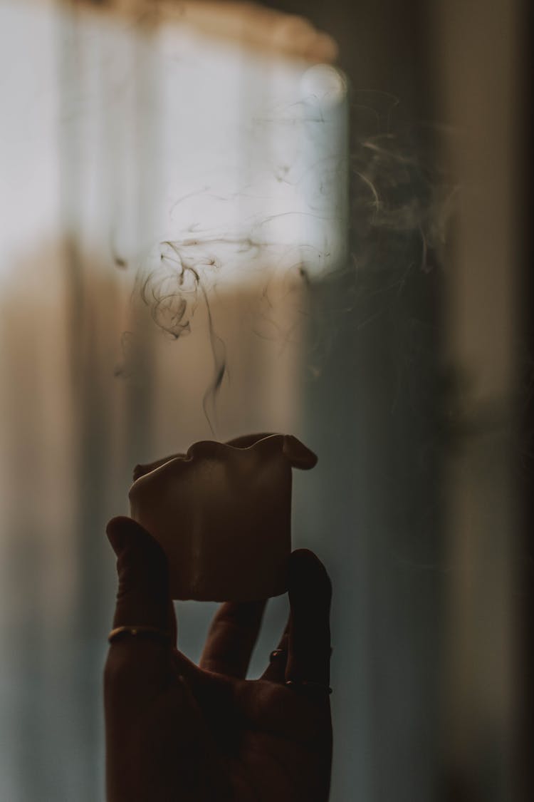 Person With Smoking Candle In Room