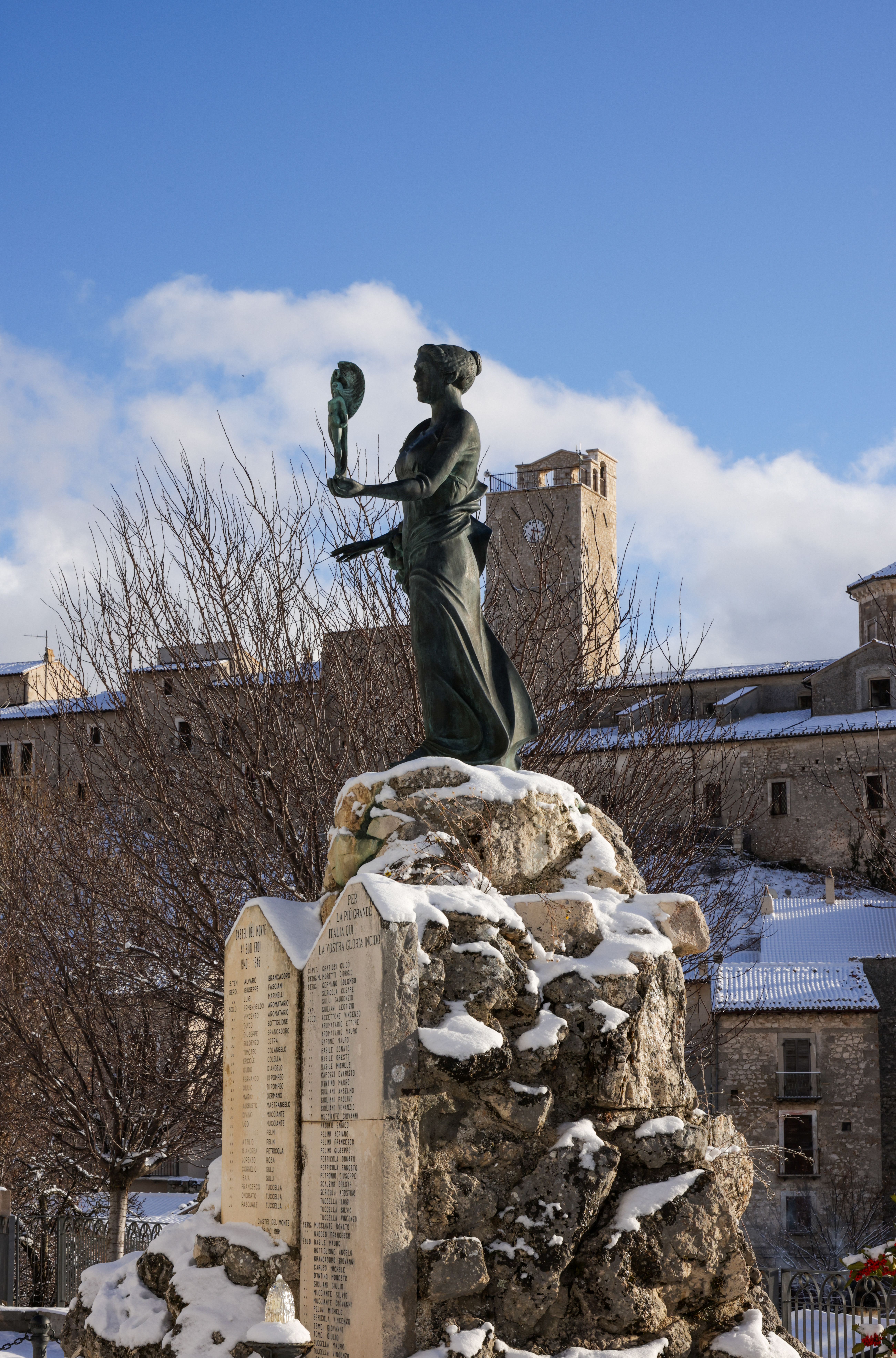 A statue in a snowy Italian village, capturing the essence of winter.