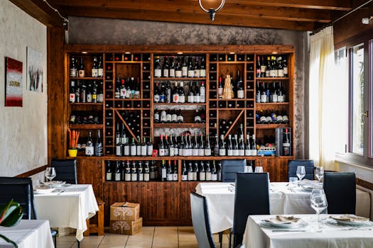 Chic restaurant interior with a comprehensive wine collection on display.