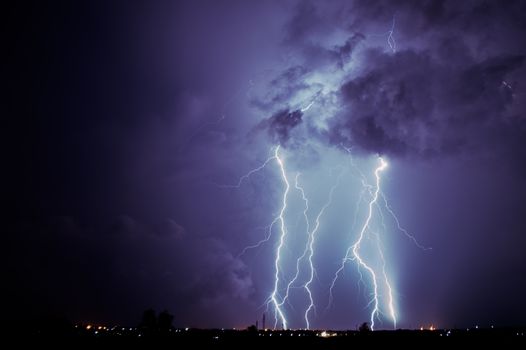 Captivating image of a powerful thunderstorm at night with striking lightning bolts illuminating the sky.