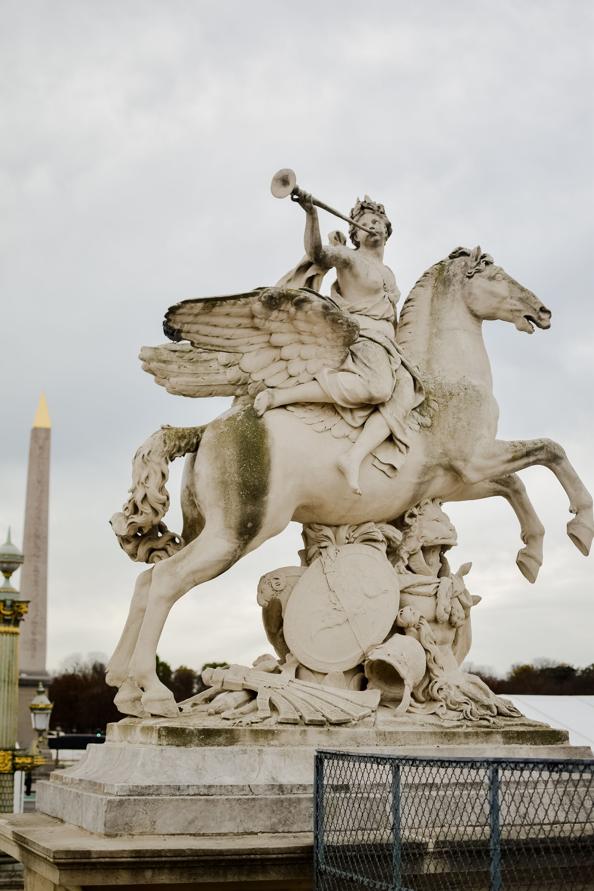 Magnificent statue of Pegasus and Fame at Place de la Concorde, showcasing neoclassical artistry in Paris.
