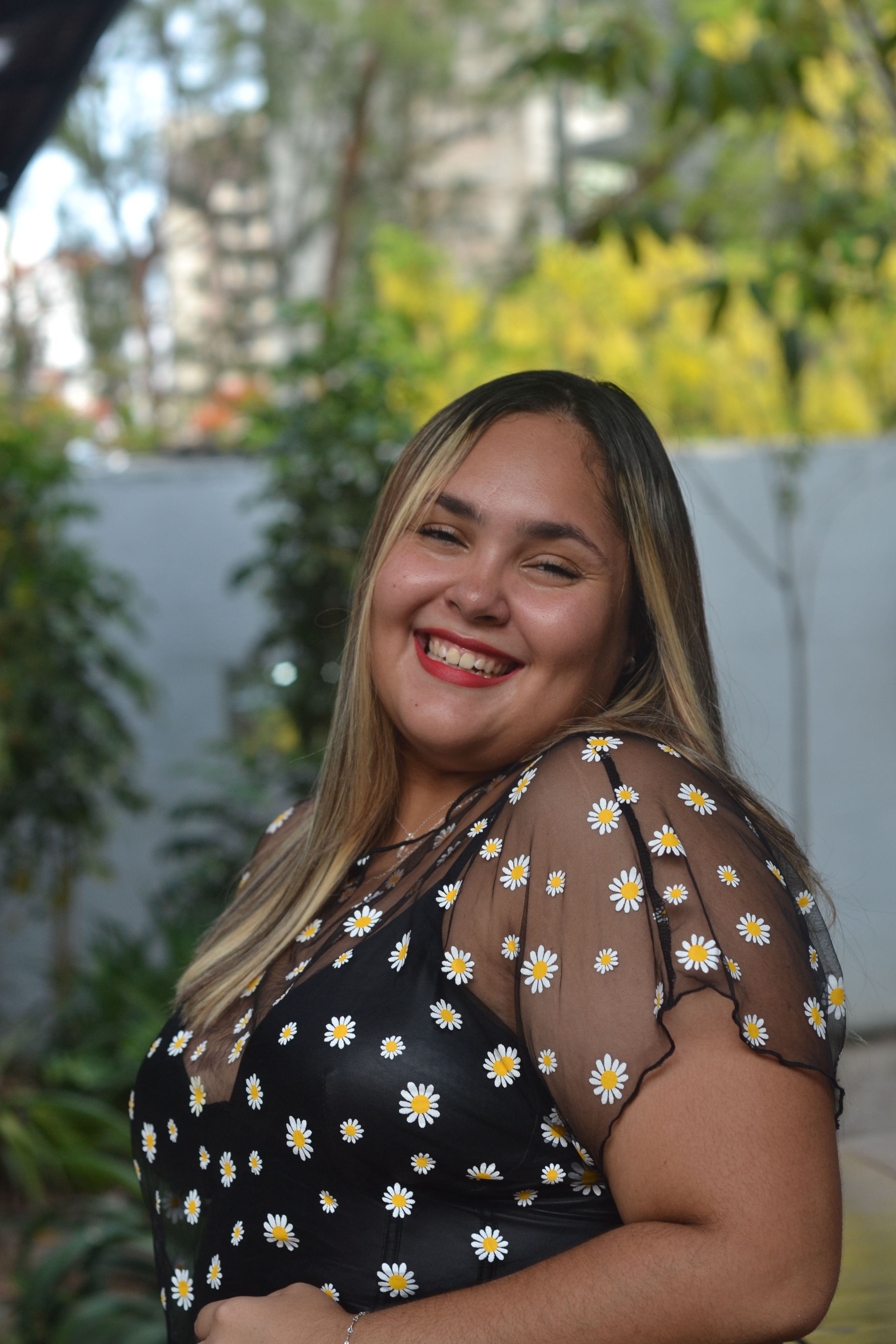 Smiling Woman in Floral Dress Outdoors · Free Stock Photo