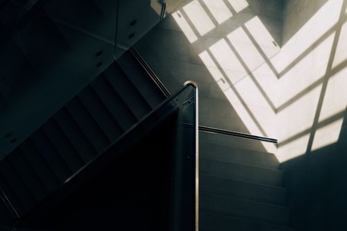 Free A staircase in Saint Petersburg with striking sunlight and geometric shadows creating an artistic abstract pattern. Stock Photo