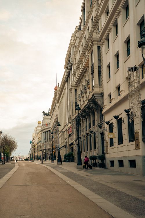 Free Quiet city street with elegant European architecture under a cloudy sky. Stock Photo