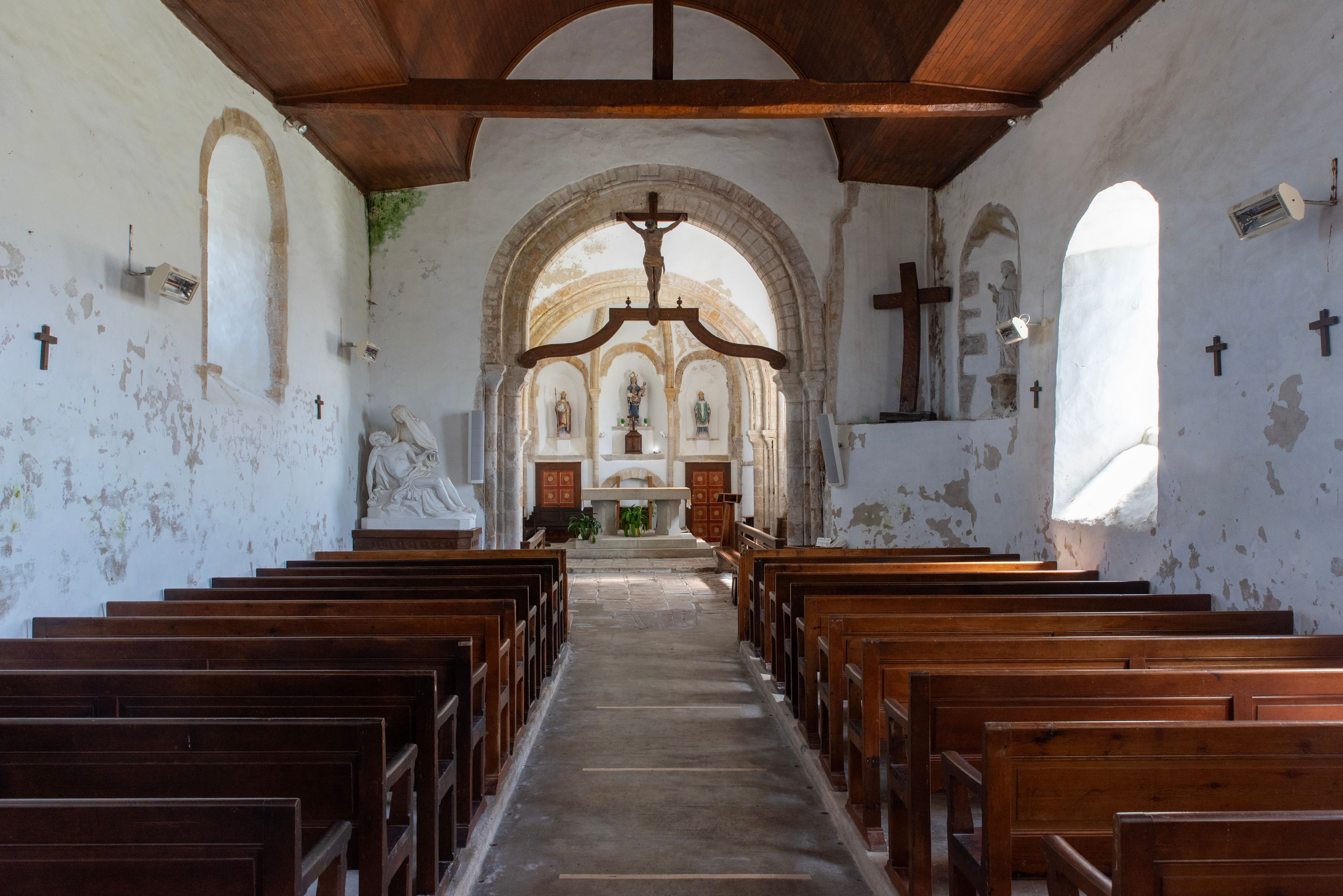 Explore the serene interior of a rustic church in La Hague, Normandië, capturing timeless architecture and peaceful ambiance.