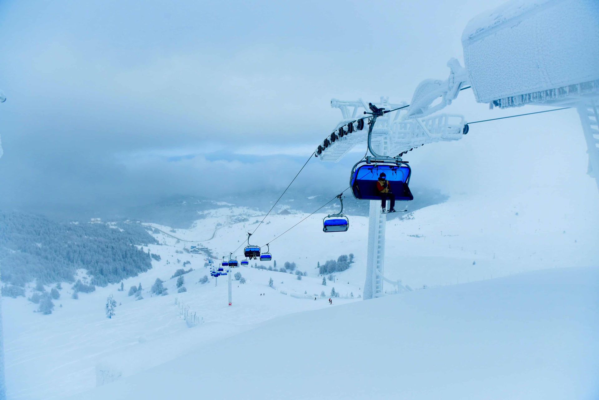 Captivating view of a ski lift covered in snow, set against the wintery landscape of Bursa, Turkey.