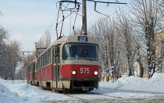 Vintage tram navigating snowy streets of Kharkiv, Ukraine in winter.