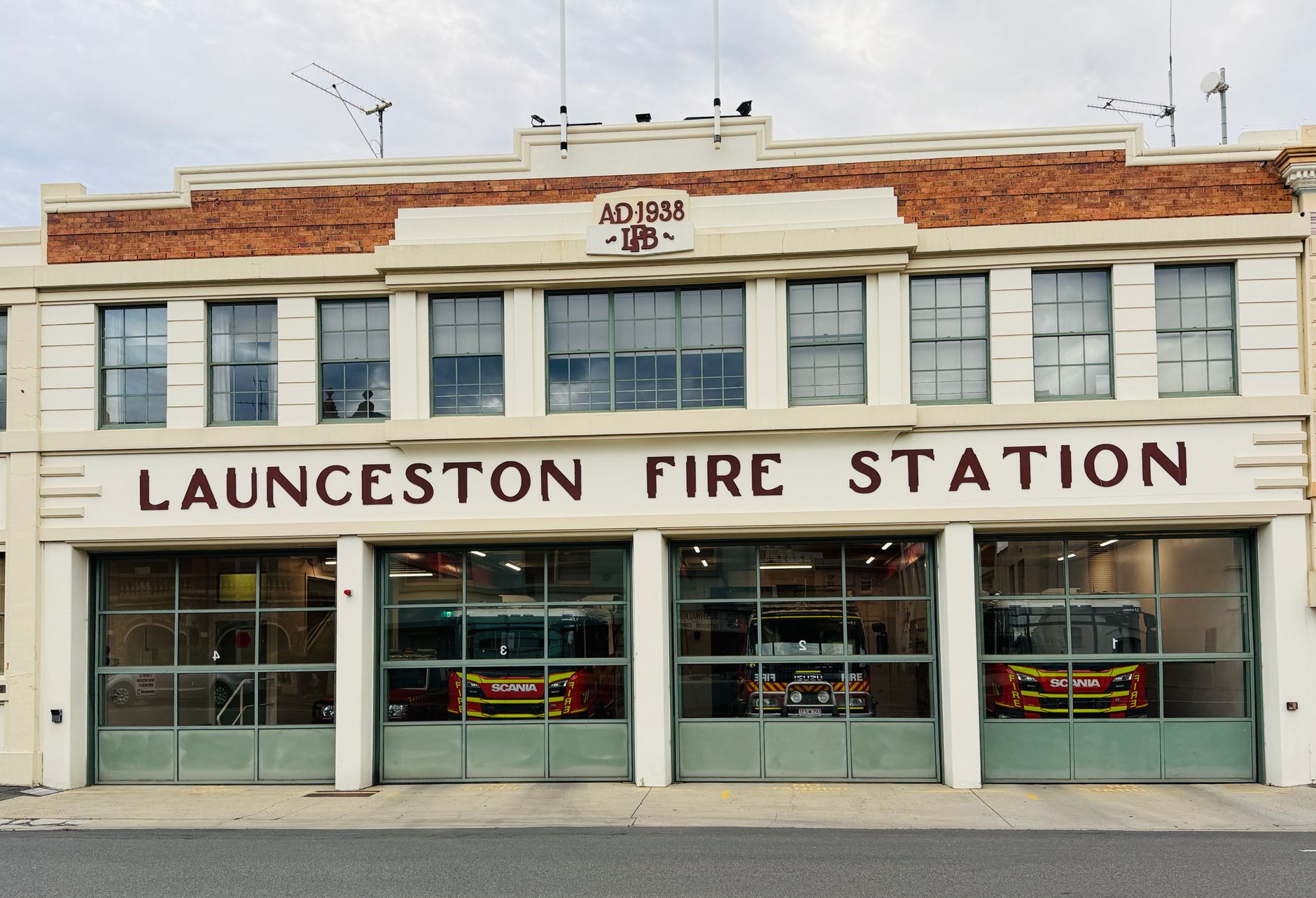 Front view of the historic Launceston Fire Station with fire trucks visible inside.