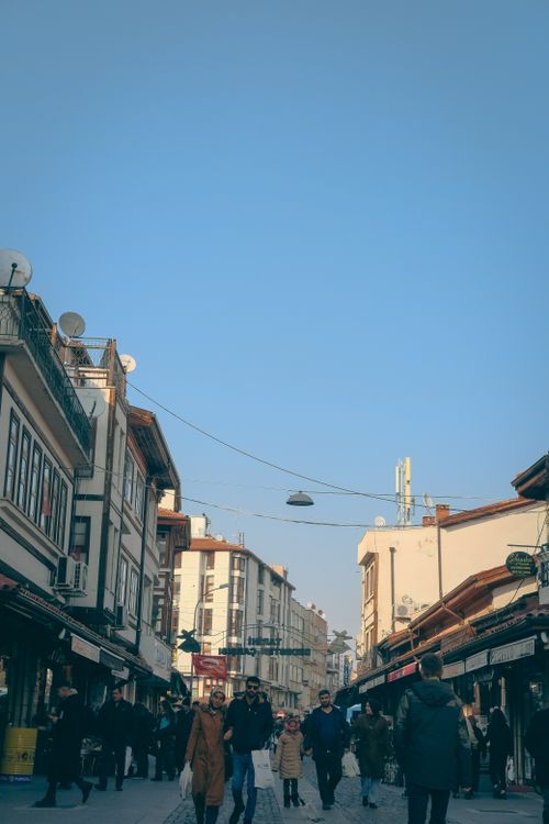 Free People walking on a vibrant street in Konya, Türkiye under a clear blue sky. Stock Photo