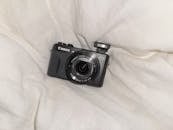Compact Digital Camera on Soft White Fabric