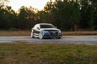 Sleek Black Sedan on Road at Dusk