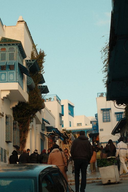 Free Explore the vibrant streets of Sidi Bou Said, capturing the essence of Tunisian architecture. Stock Photo