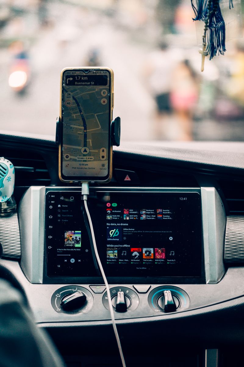 Interior view of car dashboard with GPS and music display, creating a modern travel vibe.