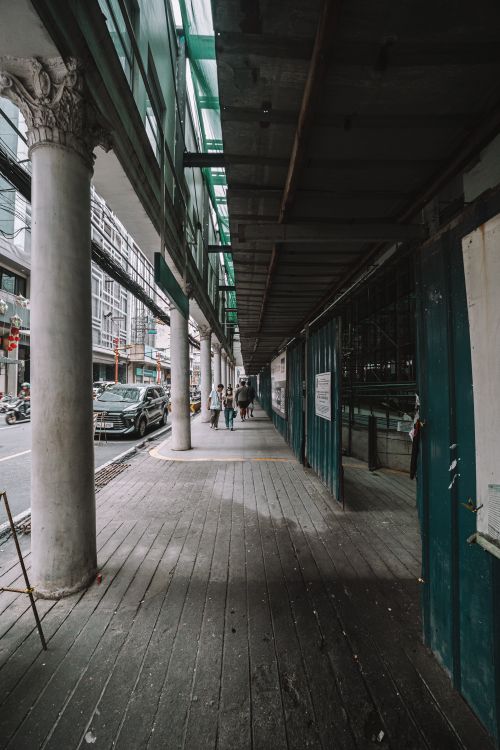 Free City street view with architectural columns and an underpass, capturing an urban scene. Stock Photo