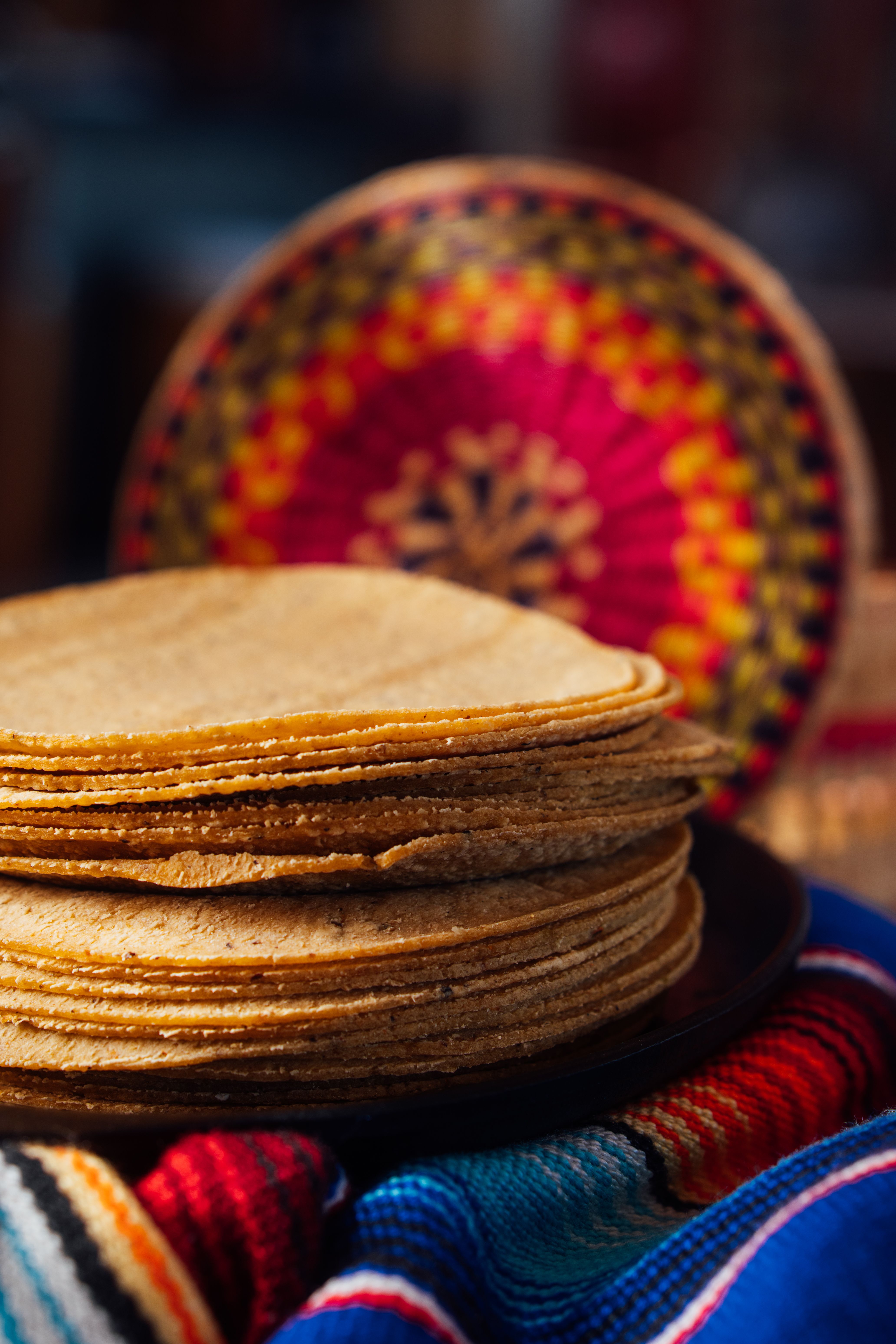Stack of Tortillas on Colorful Mexican Textile · Free Stock Photo