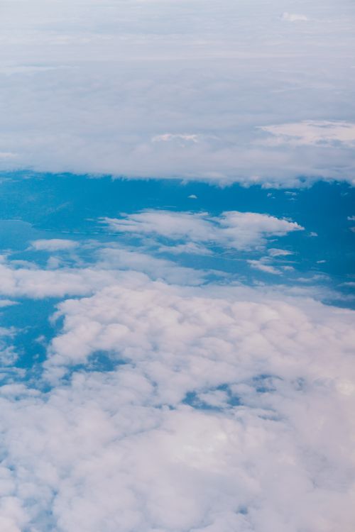 Free Serene aerial view capturing layers of clouds from an airplane. Stock Photo