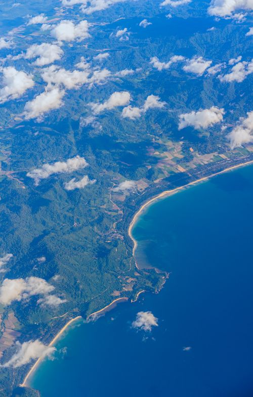 Free A stunning aerial view of a coastline with clouds and ocean. Stock Photo