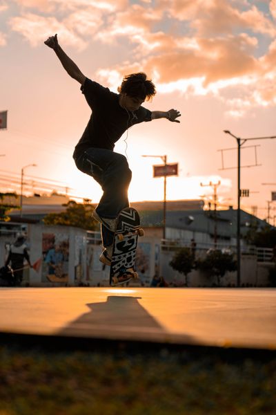 Skateboarder mid-trick against a vivid sunset, photo by Juan Jesus Madrigal Herrera on Pexels