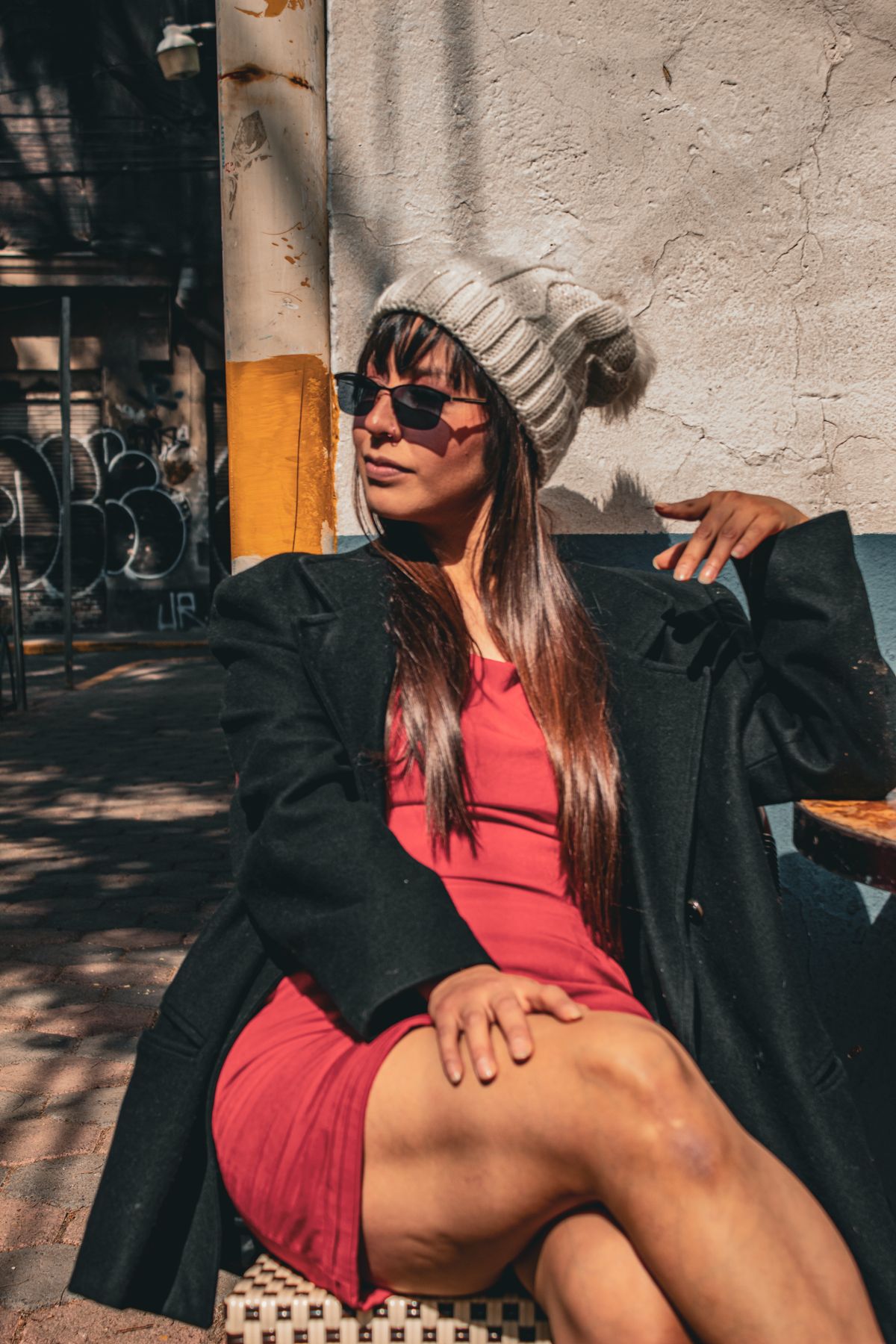 Latina woman in high-waisted wide-leg pants and a fitted crop top