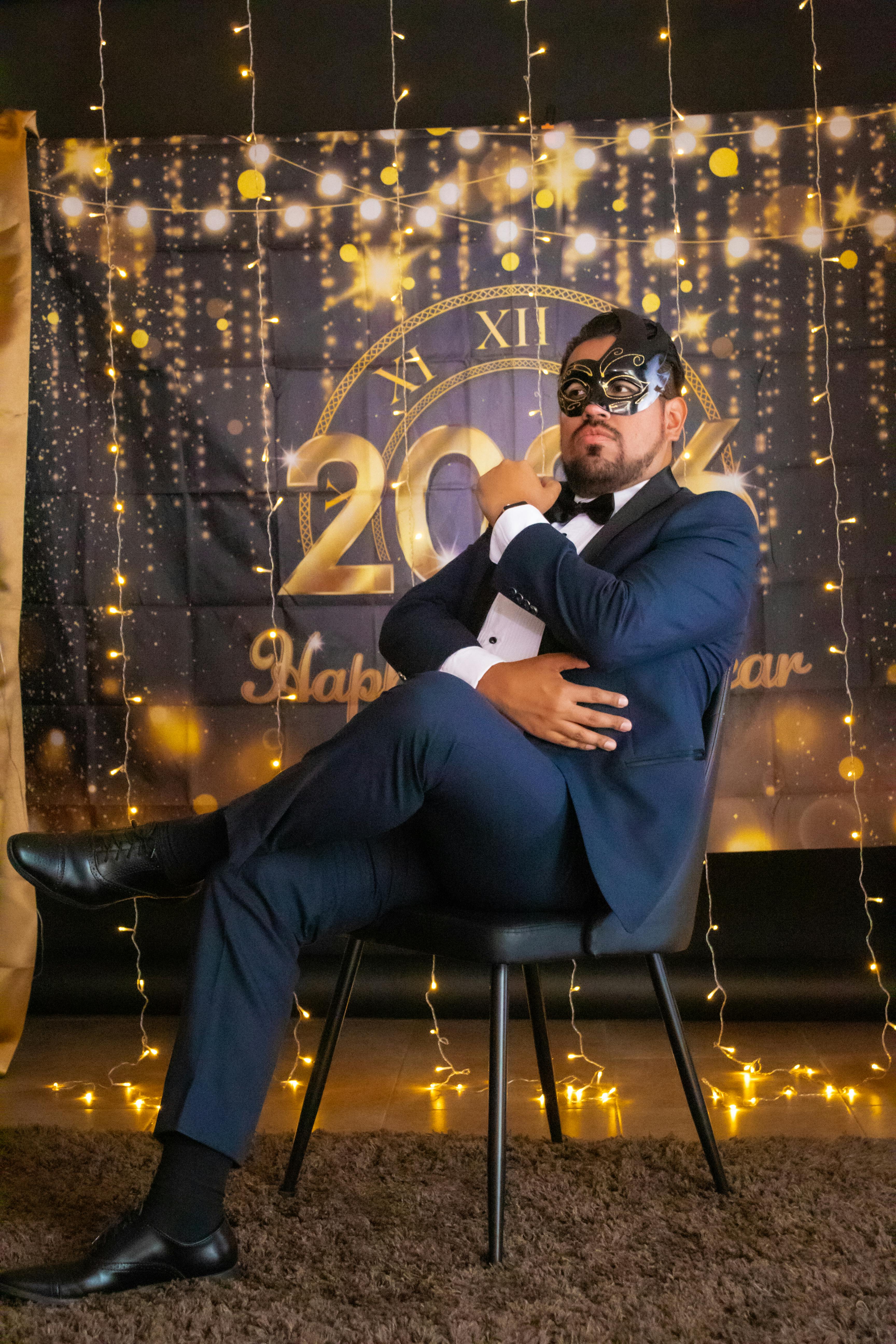 Man in tuxedo at New Year's Eve masquerade ball in Mexico City, festive and elegant atmosphere.