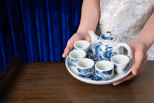 Free Beautiful Chinese blue and white tea set on a wooden table, perfect for elegant tea ceremonies. Stock Photo