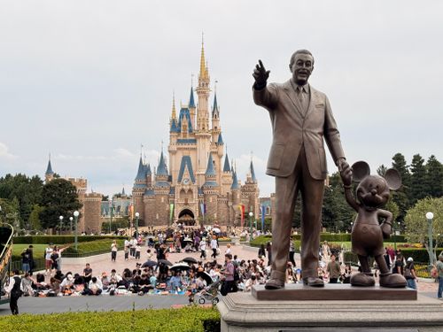Free Statue of Walt Disney and Mickey Mouse in front of Cinderella Castle, Tokyo Disneyland. Stock Photo