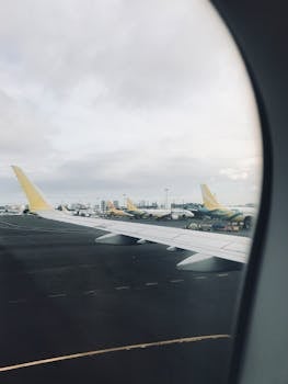 Aerial view of airplanes parked at Manila airport, captured from a plane window.