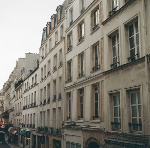 Free A charming view of Parisian architecture along a quiet street in the daytime. Stock Photo