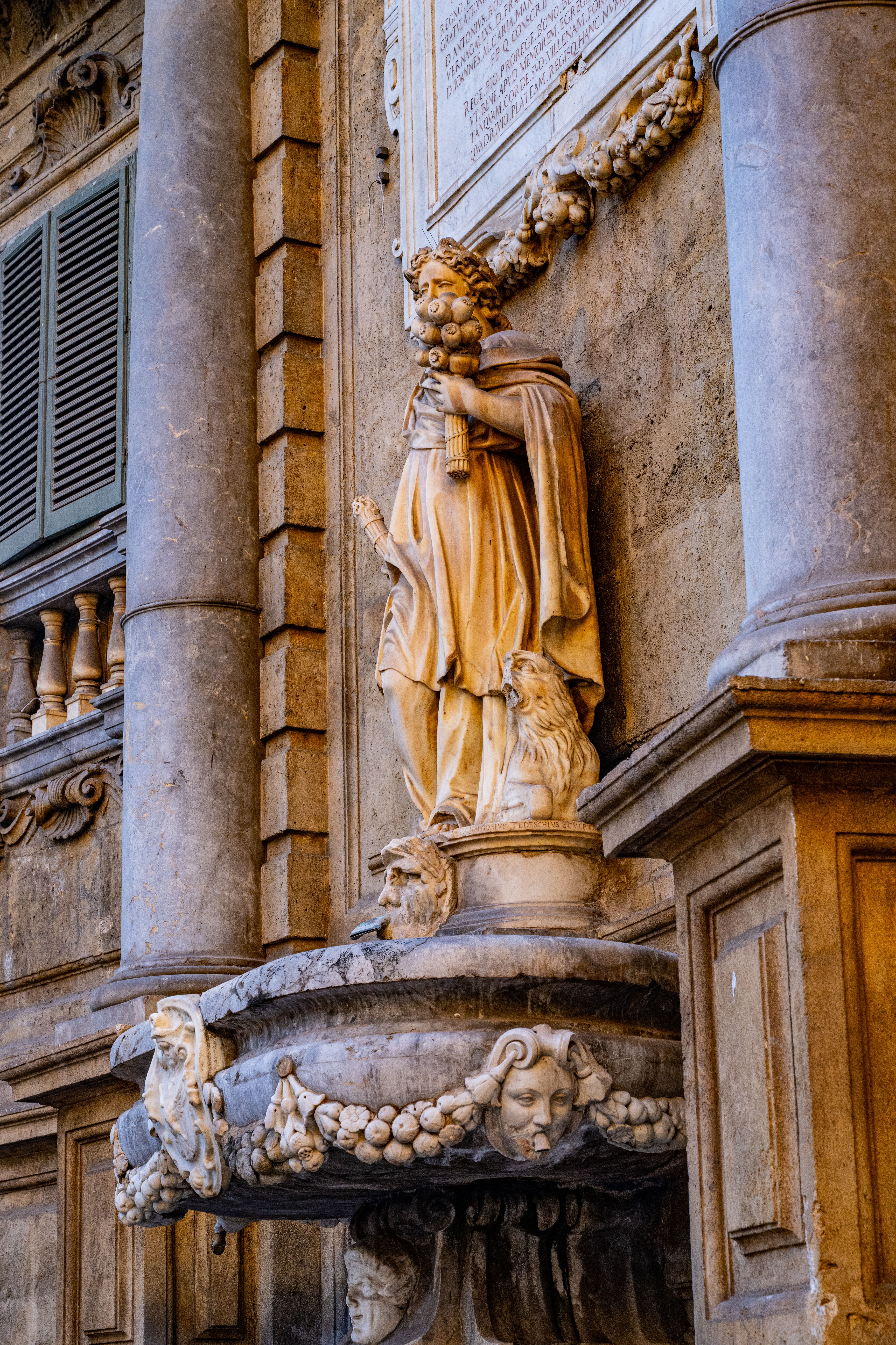 Intricate Baroque statue adorning the Quattro Canti in Palermo, showcasing stunning architectural detail.