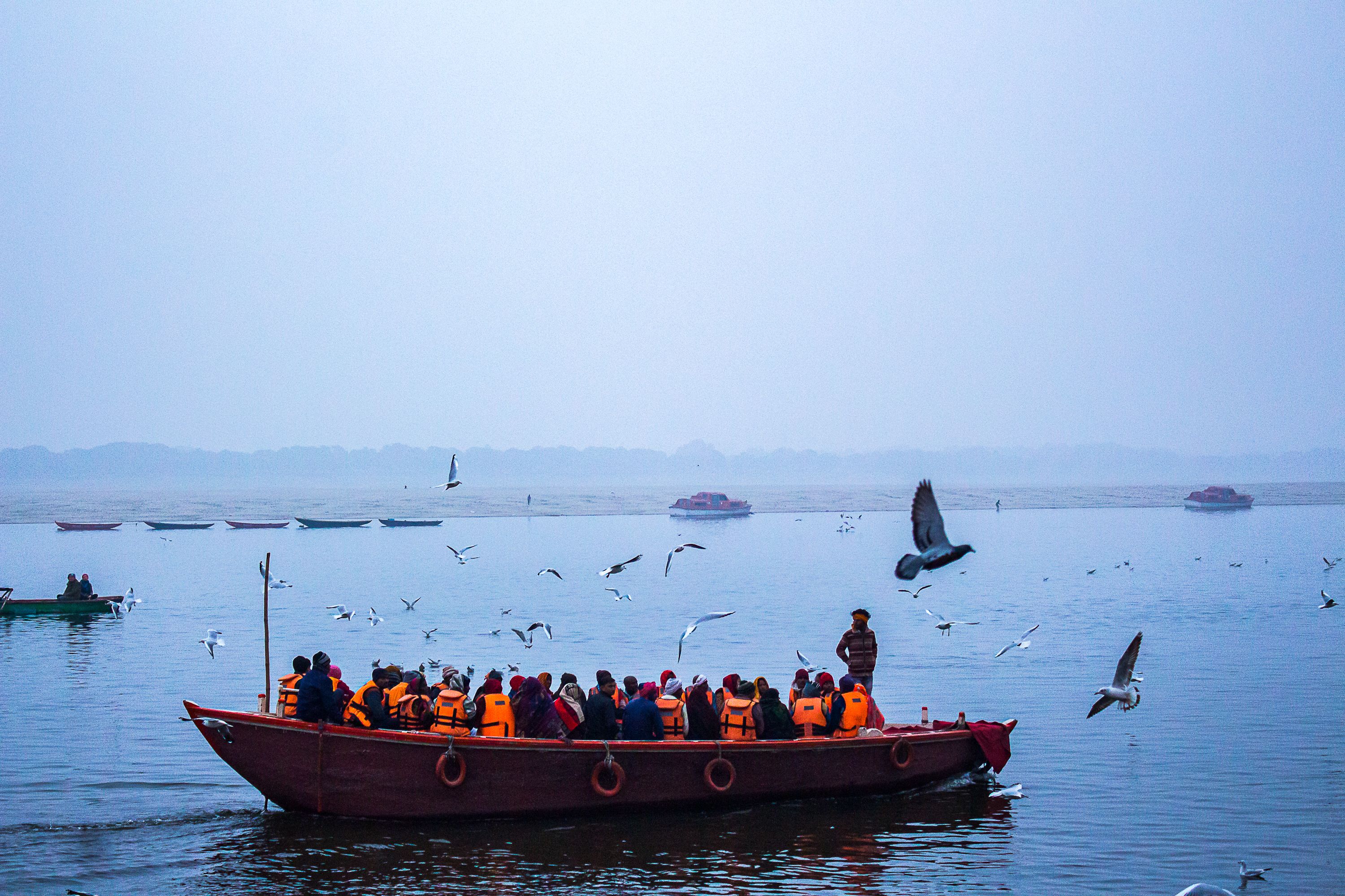 Scenic Boat Ride on a Misty Lake · Free Stock Photo