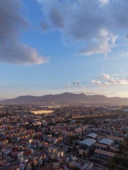 Stunning aerial view of Guadalajara with mountains and colorful sunset sky.