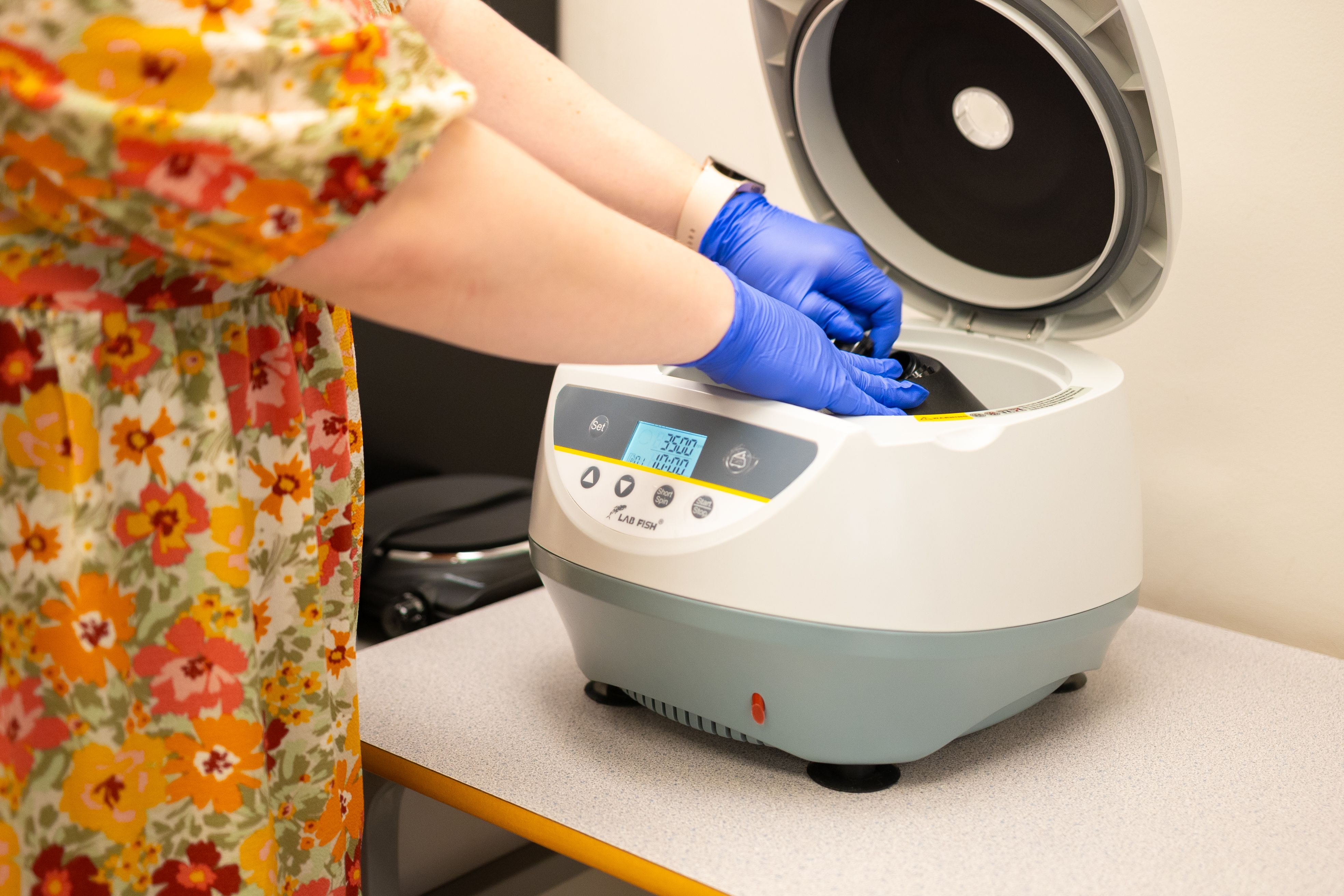 Scientist Operating Laboratory Centrifuge Equipment · Free Stock Photo