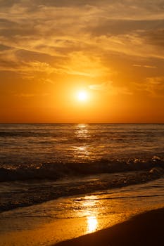 Experience the serene beauty of a golden sunset on the El Salvador coast, capturing nature's tranquil essence.