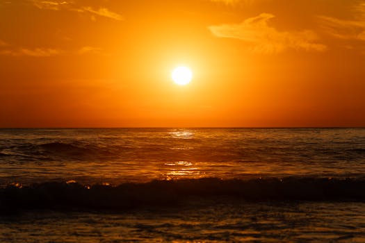 Soothing ocean waves at sunset in El Salvador's golden hour.