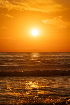 Stunning golden sunset reflecting over the beach waves in El Salvador, capturing the essence of tranquility.