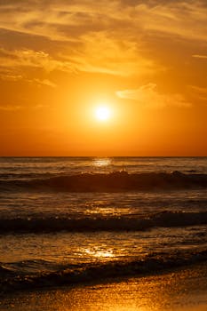 Stunning golden sunset over the waves at a beach in El Salvador.
