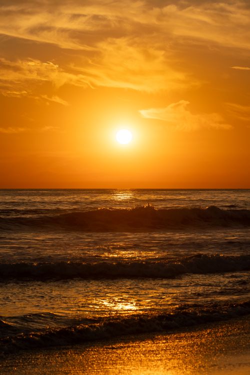 Free Stunning golden sunset over the waves at a beach in El Salvador. Stock Photo