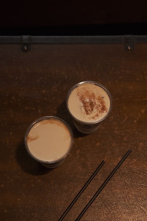 Free Two iced coffee drinks with straws on a wooden table, perfect for a cozy ambiance. Stock Photo