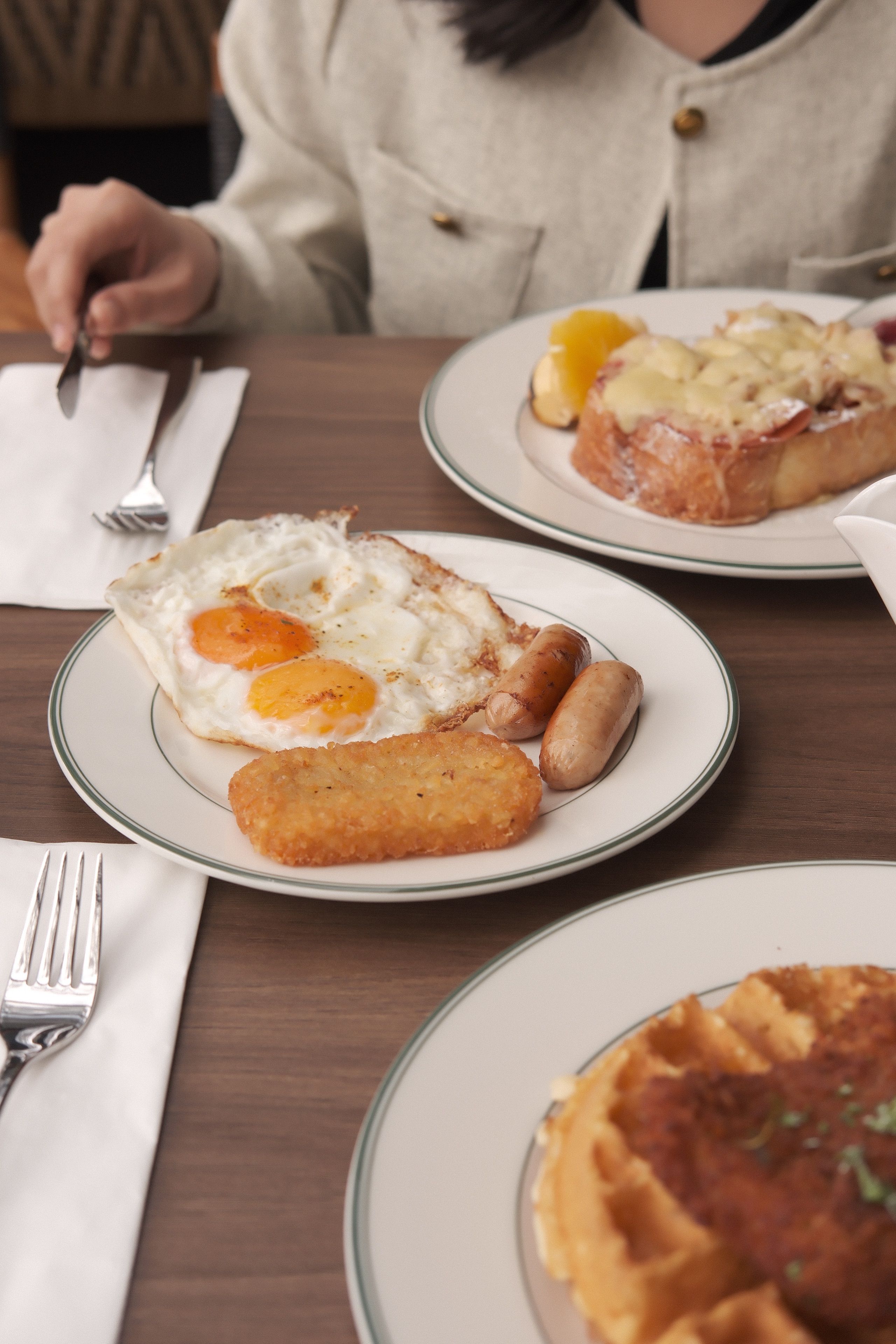 A tasty breakfast spread featuring fried eggs, waffles, and more, perfect start to the day.