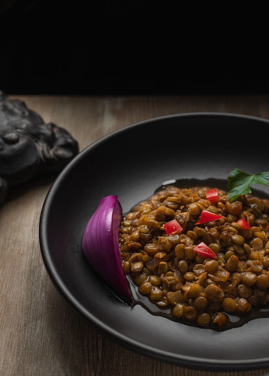 Bowl of Ethiopian misir wot red lentil stew with visible spices and rich reddish-brown color
