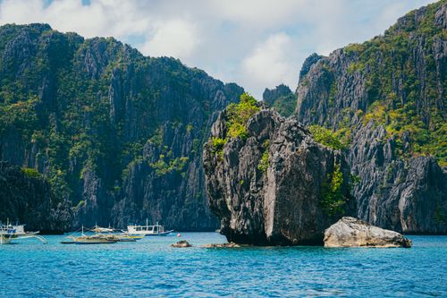 Free Breathtaking view of tropical rock formations and boats in El Nido, Palawan. Stock Photo