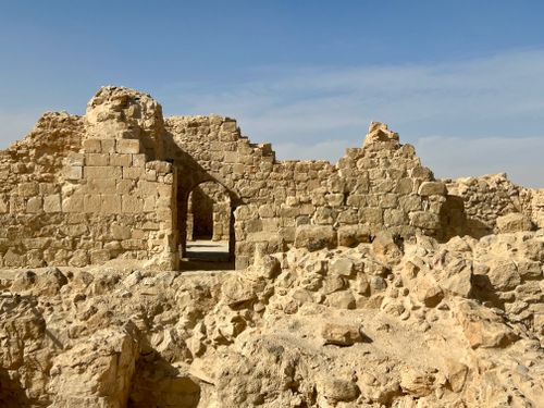 Free Explore ancient stone ruins in a desert landscape under a vivid blue sky. Stock Photo