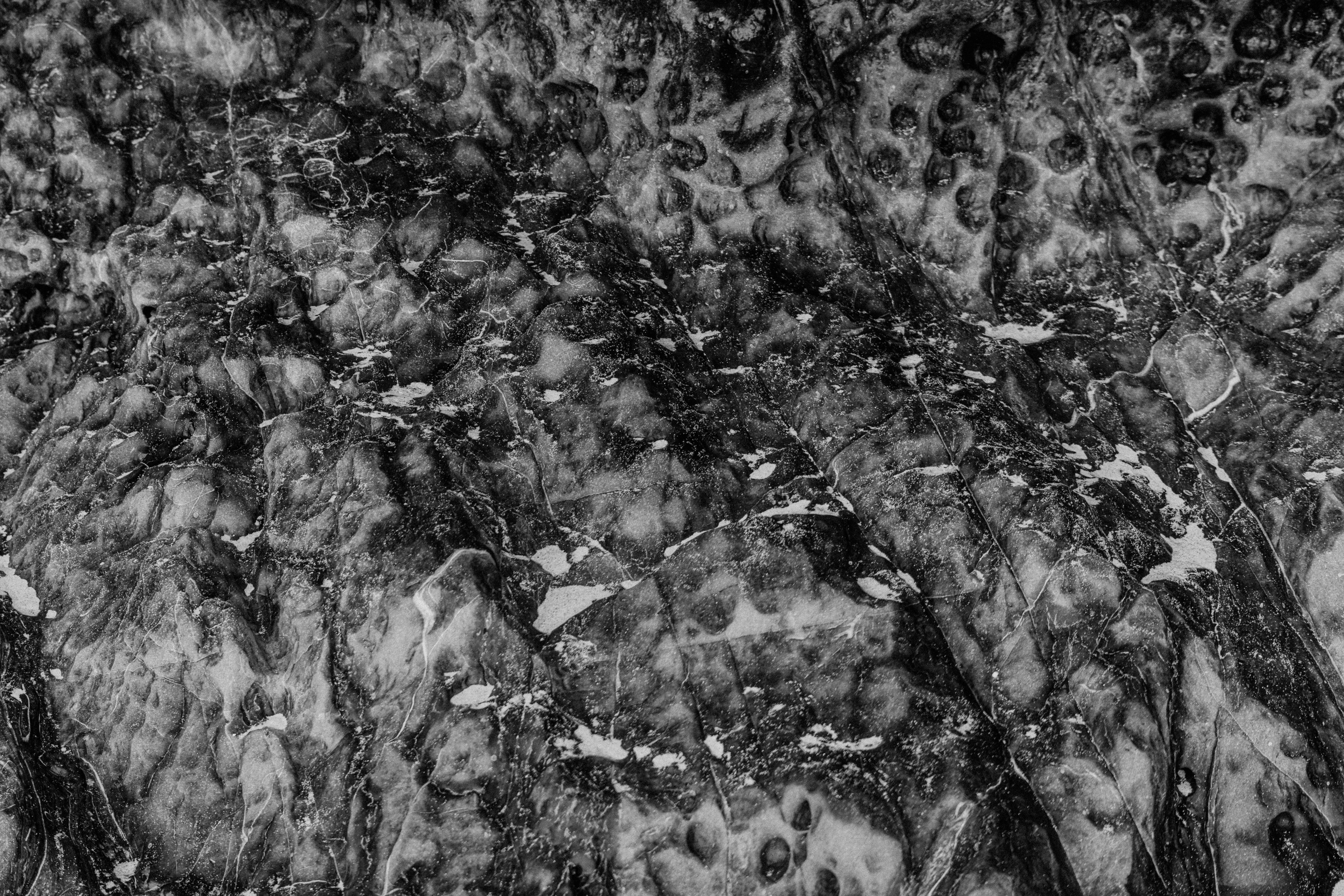 Close-up of a black and white marble texture showing natural intricate patterns.