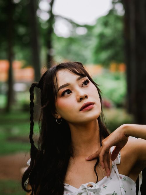 Free Elegant portrait of a woman in a serene Jakarta park, capturing nature's beauty. Stock Photo