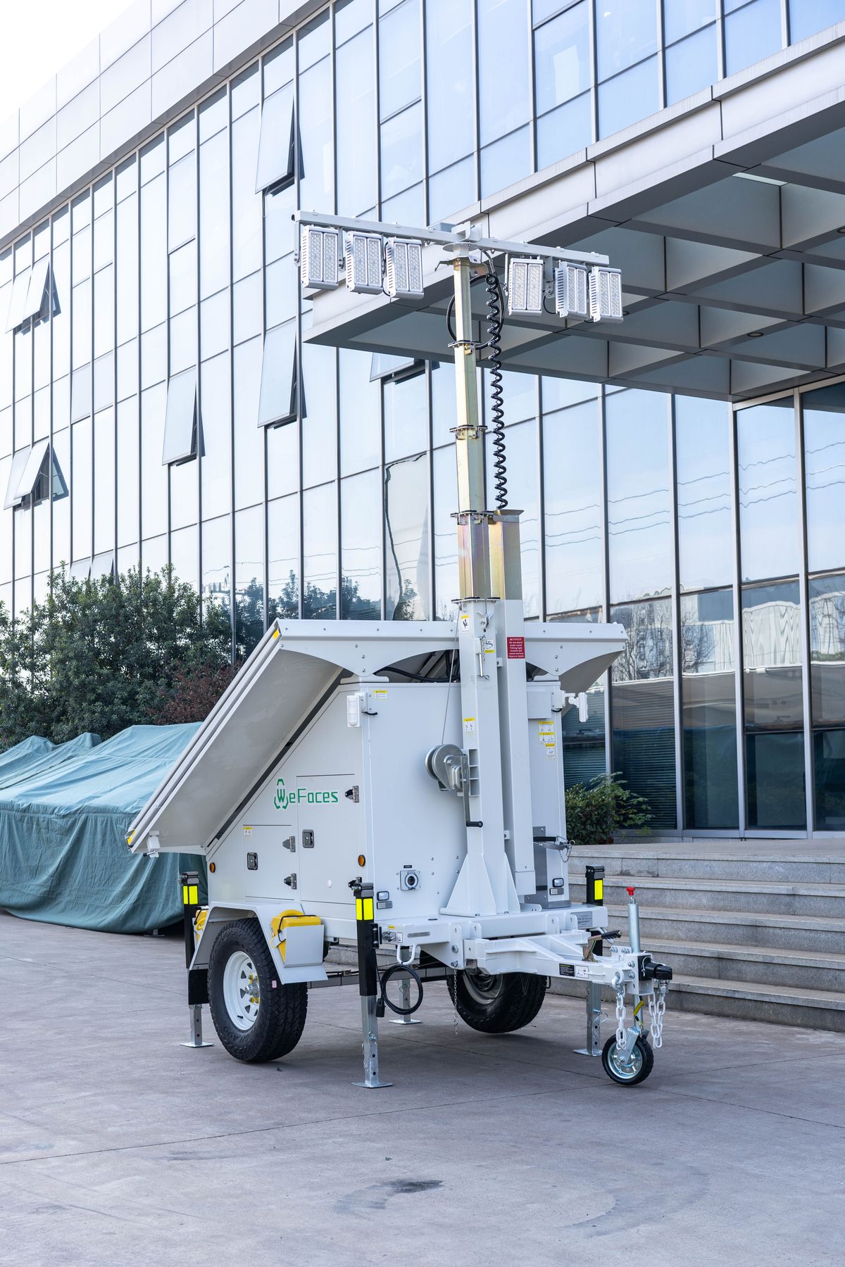 Trailer-mounted light tower with mast raised and outriggers deployed, the unit type rented at a fixed monthly rate